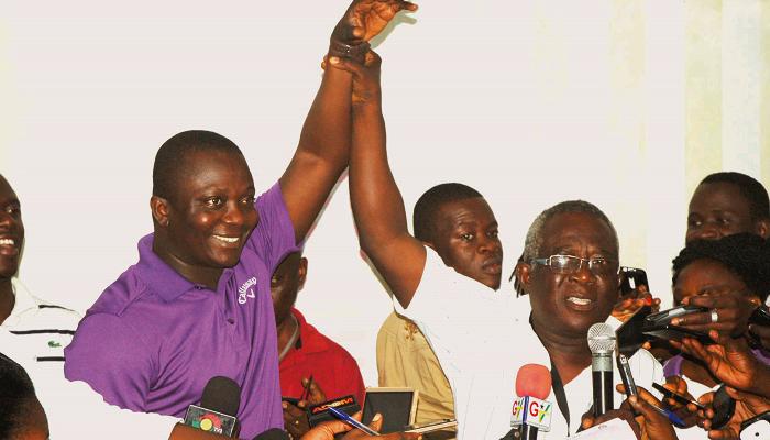 Mr Michael Agyekum Ansong, the District Returning Officer of the Electoral Commission (EC), proclaiming Mr Acheampong (left) as the winner